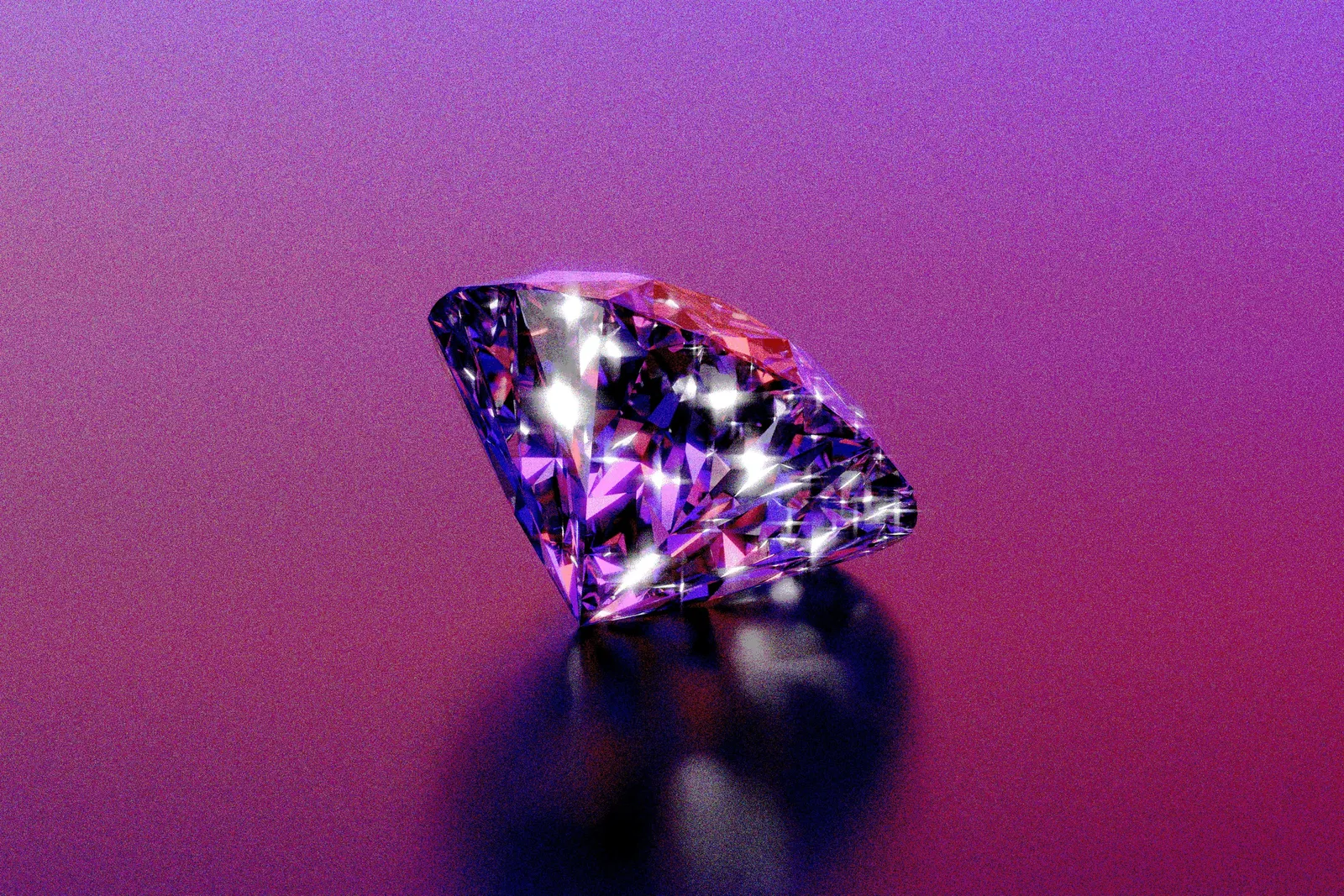 A sparkling purple diamond on a glossy pink and purple surface